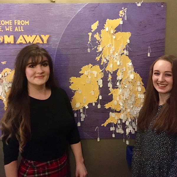 Pippa and her companion pin themselves on the Come From Away map