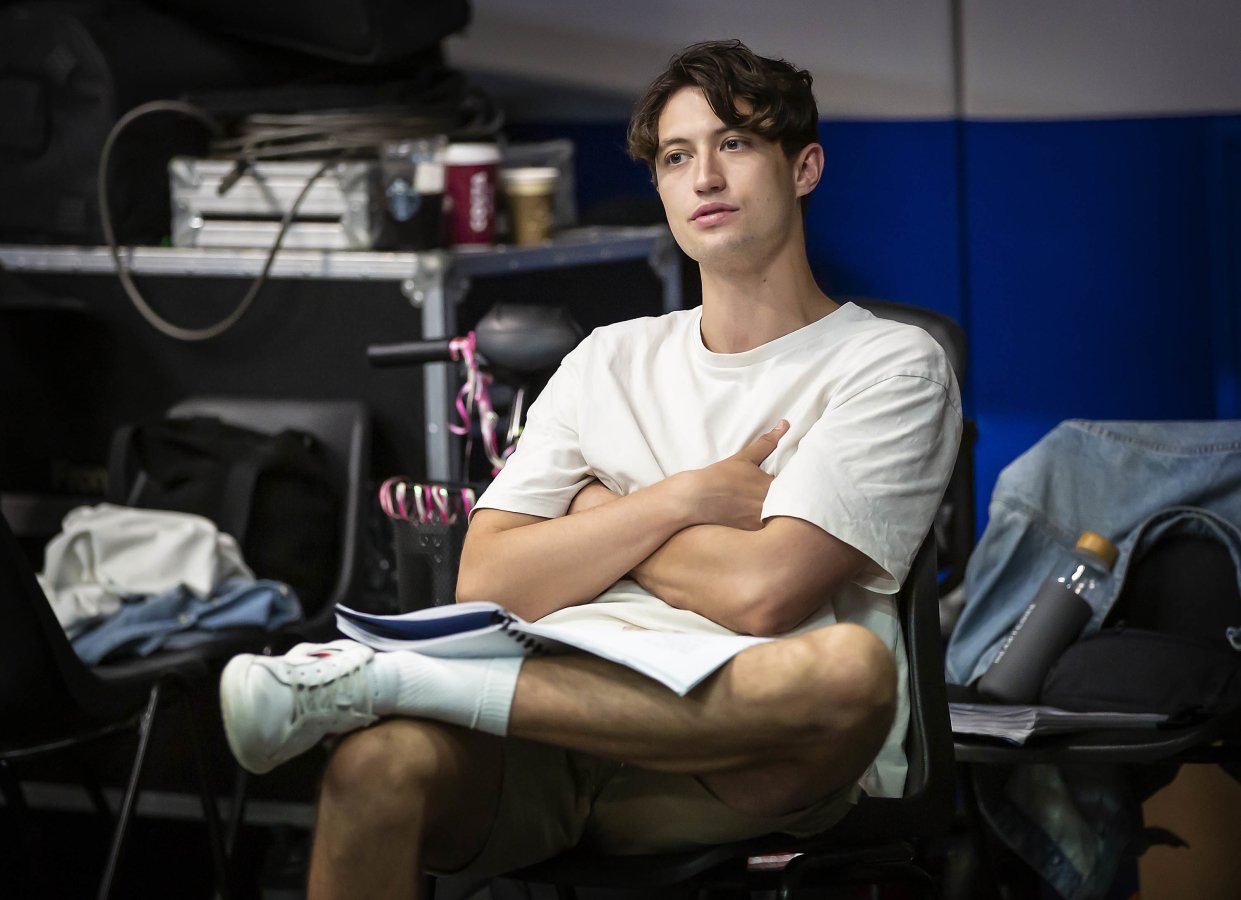 Jordan Luke Gage sits with legs crossed and a script resting on his lap