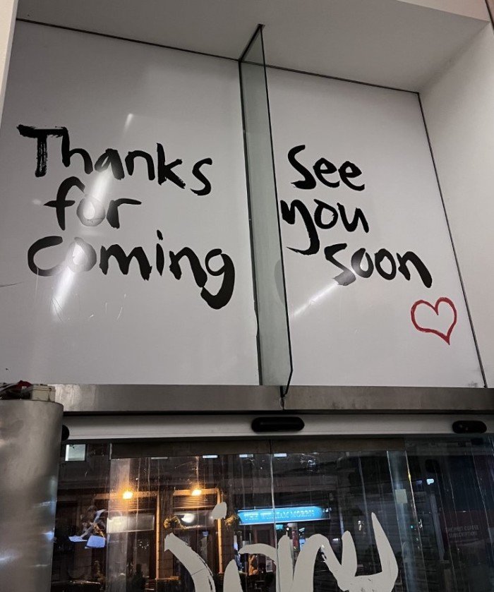A photo of the Lyric Hammersmith Theatre's exit which says 'Thanks for coming' and 'See you soon'