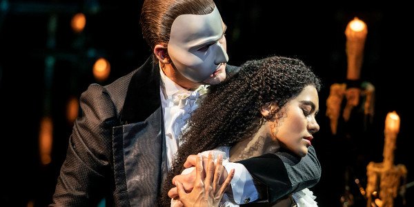 Christine and the phantom embracing eachother