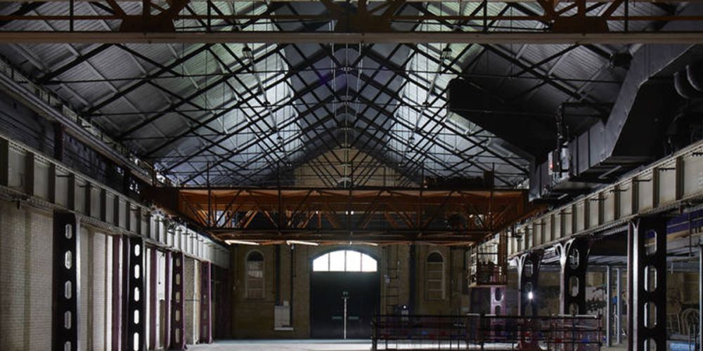 A close-up of a cartridge with a black and orange design, resting on a textured grey surface.