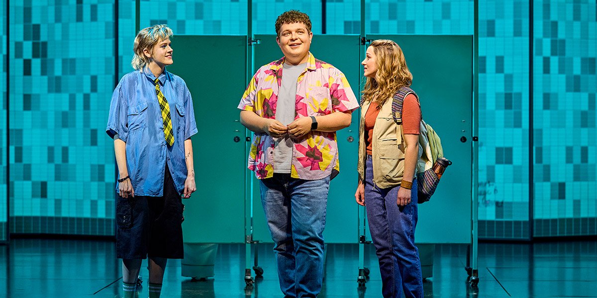 Elena Skye (Janis), Tom Xander (Damian) and Charlie Burn (Cady) in front of three toilet cubicles.
