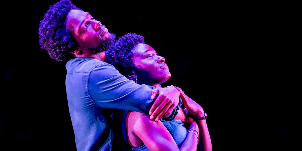 Tosin Cole and Heather Agyepong in an embrace, both facing to the right.