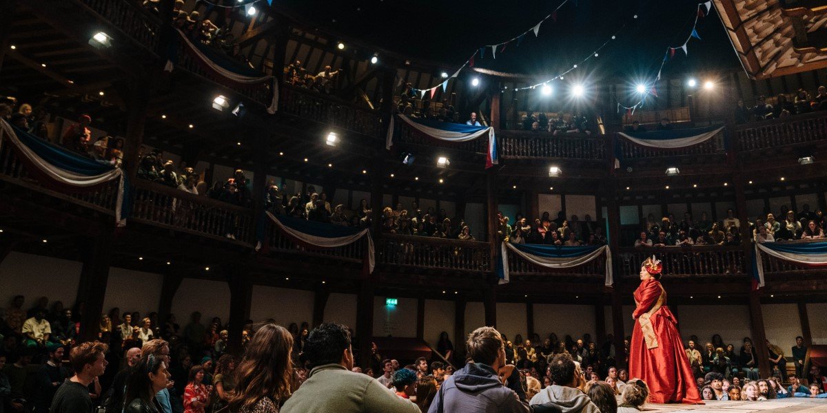 Anne Odeke looks out over a full audience at Shakespeare's Globe.